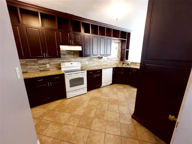 a kitchen with stainless steel appliances granite countertop a stove and a refrigerator