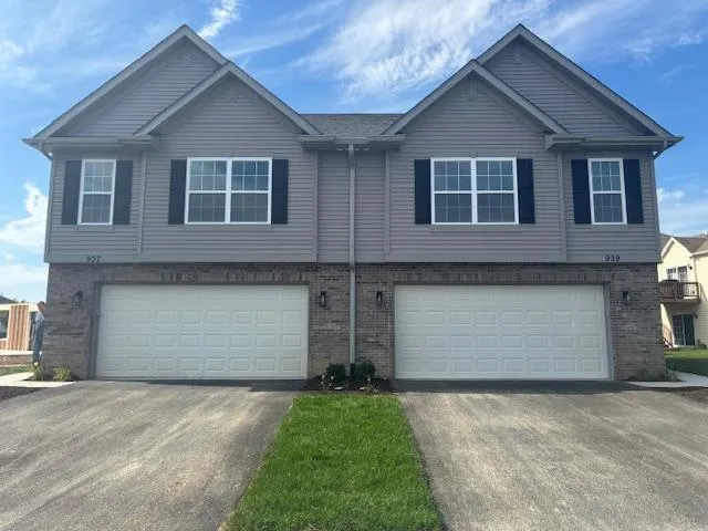 a front view of house with a yard and garage