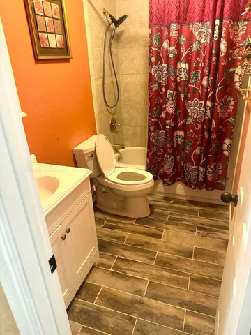 a bathroom with a toilet and a shower