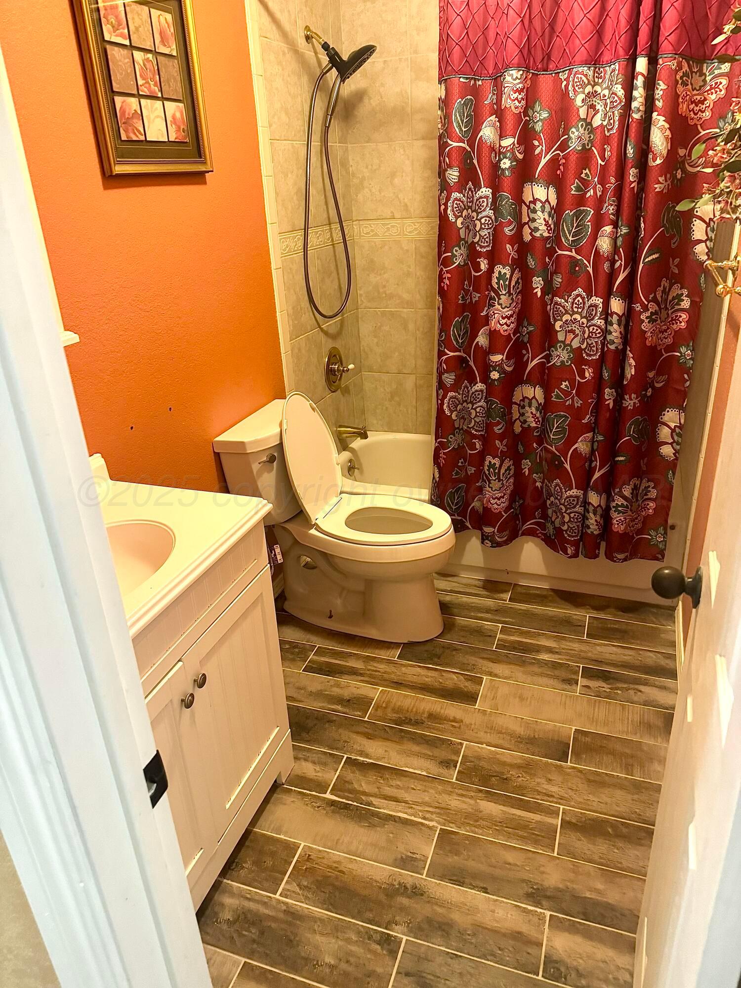 204 Garrett Street Borger, TX 79007 - Photo 15 of 23 a bathroom with a toilet and a shower