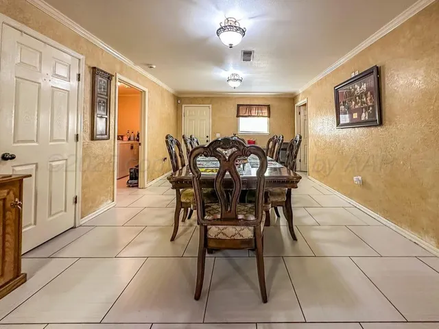 a view of a dining room with furniture and chandelier