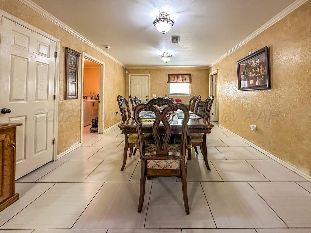 204 Garrett Street Borger, TX 79007 - Photo 10 of 23 a view of a dining room with furniture and chandelier
