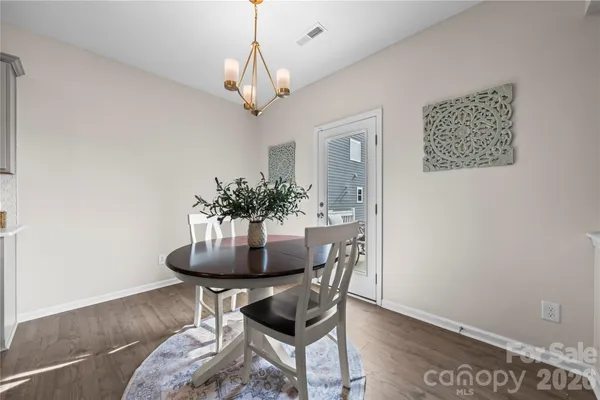 a dining room with furniture and wooden floor