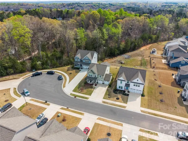 an aerial view of a house with a swimming pool