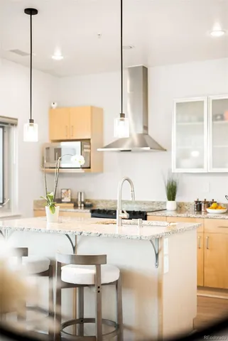 a kitchen with kitchen island granite countertop a sink and cabinets
