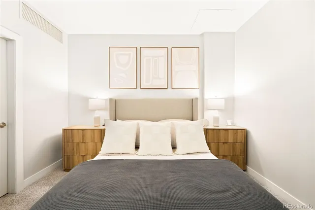 a bed room with a bed and a night stand