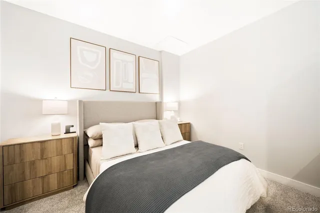 a bedroom with a white bed and cabinet