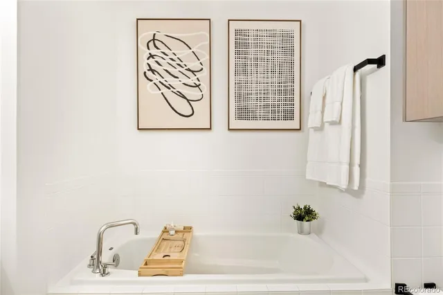 a bathroom with a bathtub and a window