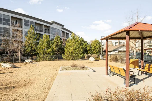 a view of a terrace with chairs and an umbrella