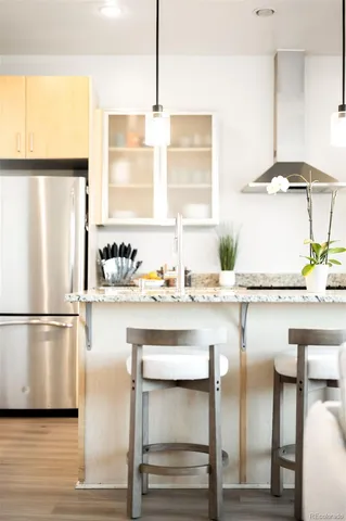 a kitchen with appliances cabinets and chair