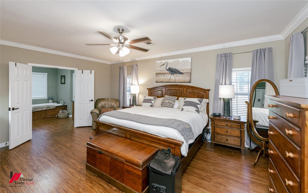 12501 Rust Lane Keithville, LA 71047 - Photo 19 of 39 a bedroom with a bed and wooden floor