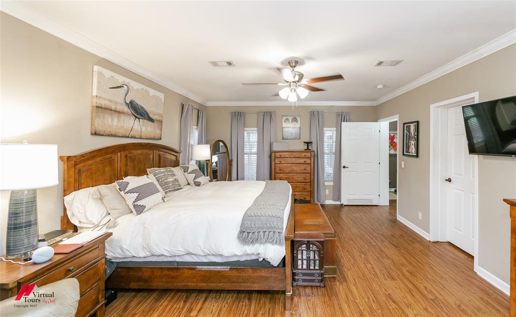 12501 Rust Lane Keithville, LA 71047 - Photo 20 of 39 a spacious bedroom with a bed and a flat screen tv