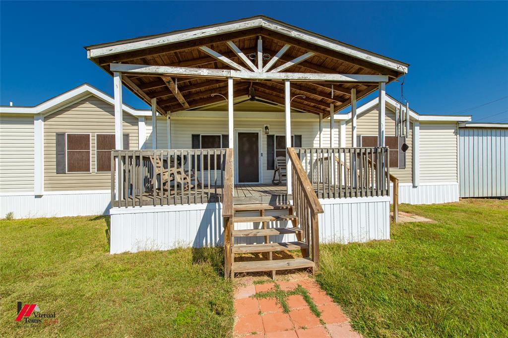 12501 Rust Lane Keithville, LA 71047 - Photo 5 of 39 a front view of a house with wooden deck and furniture