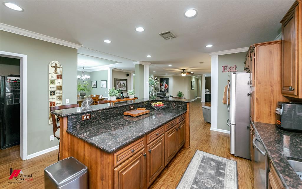 12501 Rust Lane Keithville, LA 71047 - Photo 10 of 39 a kitchen with stainless steel appliances granite countertop a refrigerator a stove and a sink