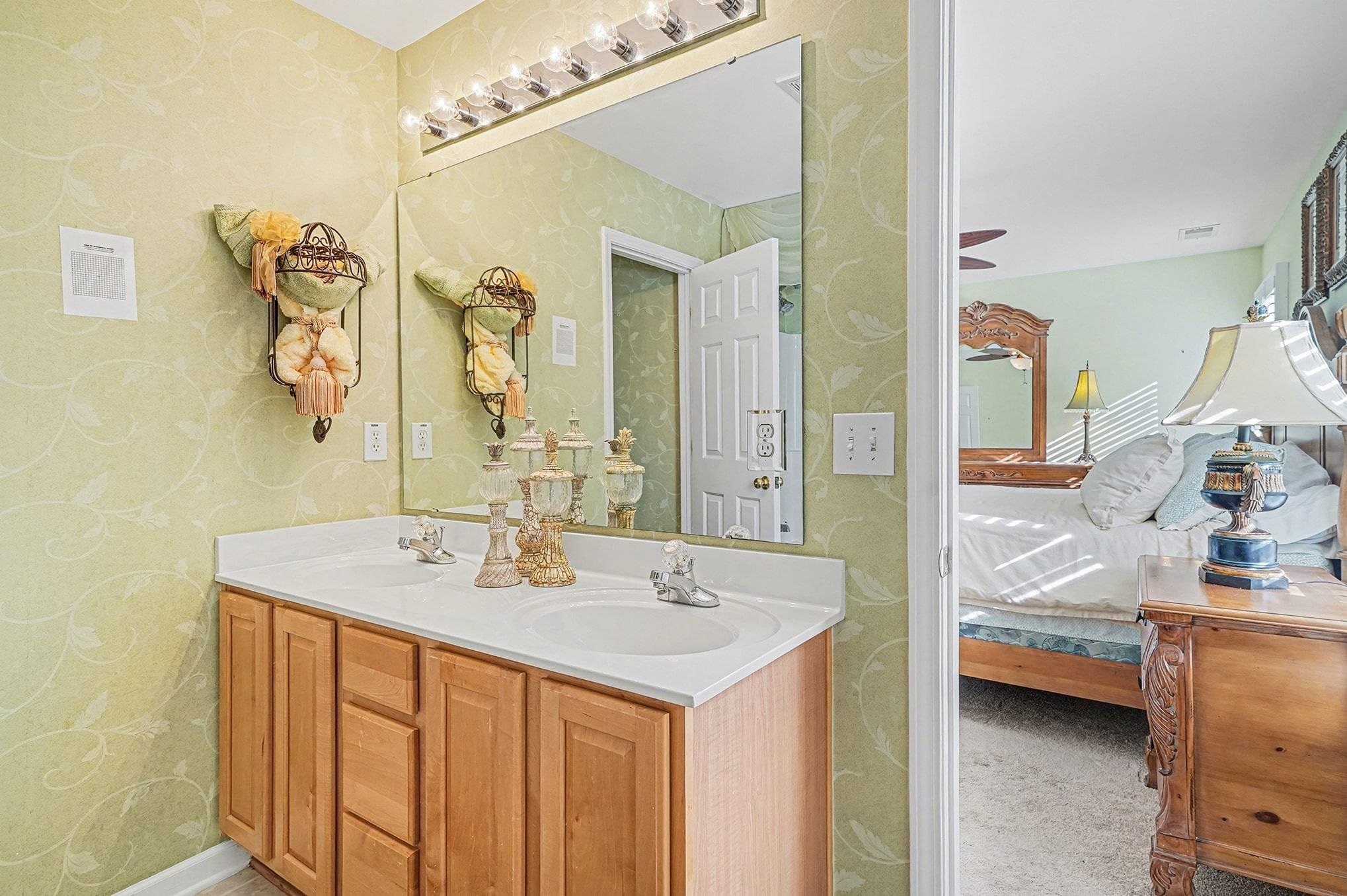 3425 Arrowhead Boulevard Myrtle Beach, SC 29579 - Photo 16 of 38 Ensuite bathroom featuring double vanity and light colored carpet