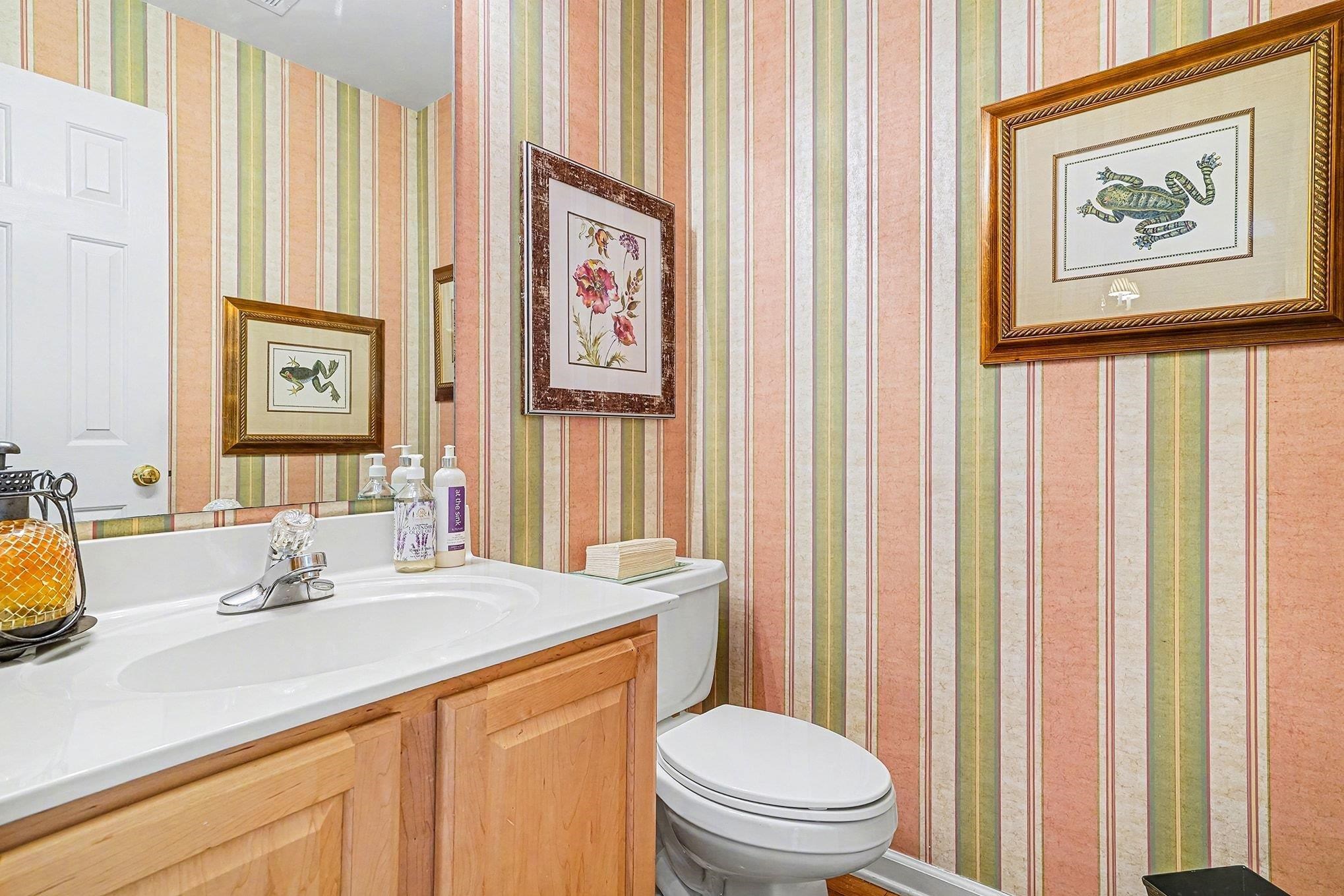 3425 Arrowhead Boulevard Myrtle Beach, SC 29579 - Photo 18 of 38 Half bath with wallpapered walls and vanity