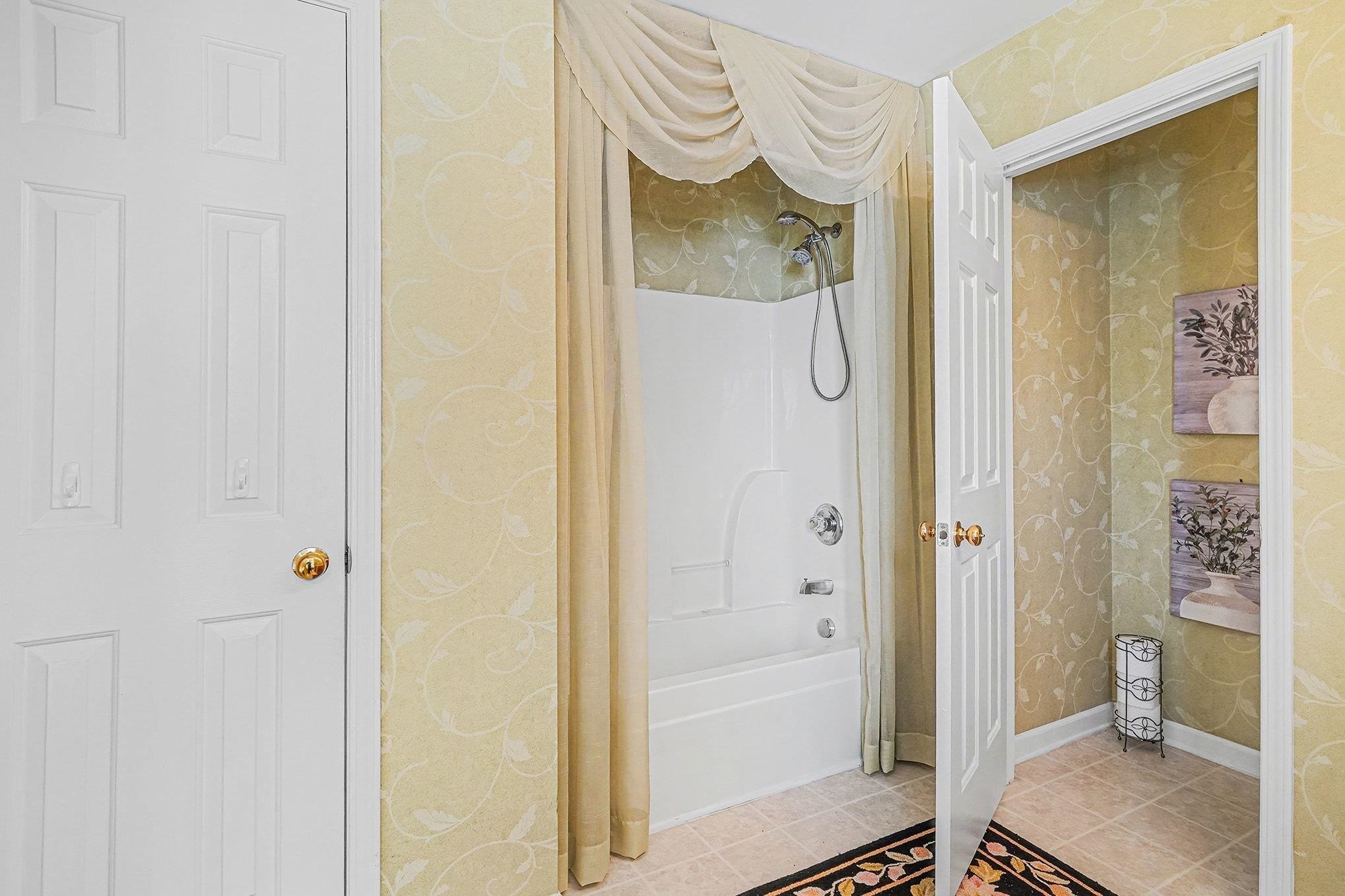 3425 Arrowhead Boulevard Myrtle Beach, SC 29579 - Photo 21 of 38 Full bath with wallpapered walls, shower / bath combination with curtain, and tile patterned flooring