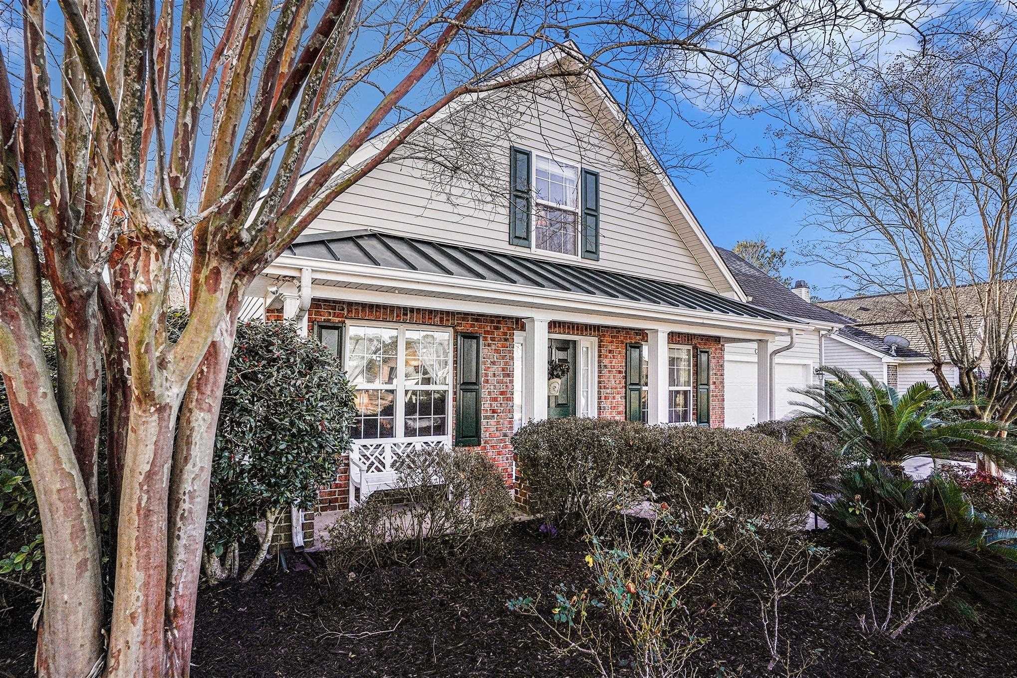3425 Arrowhead Boulevard Myrtle Beach, SC 29579 - Photo 3 of 38 View of front facade featuring a standing seam roof, brick siding, and a metal roof