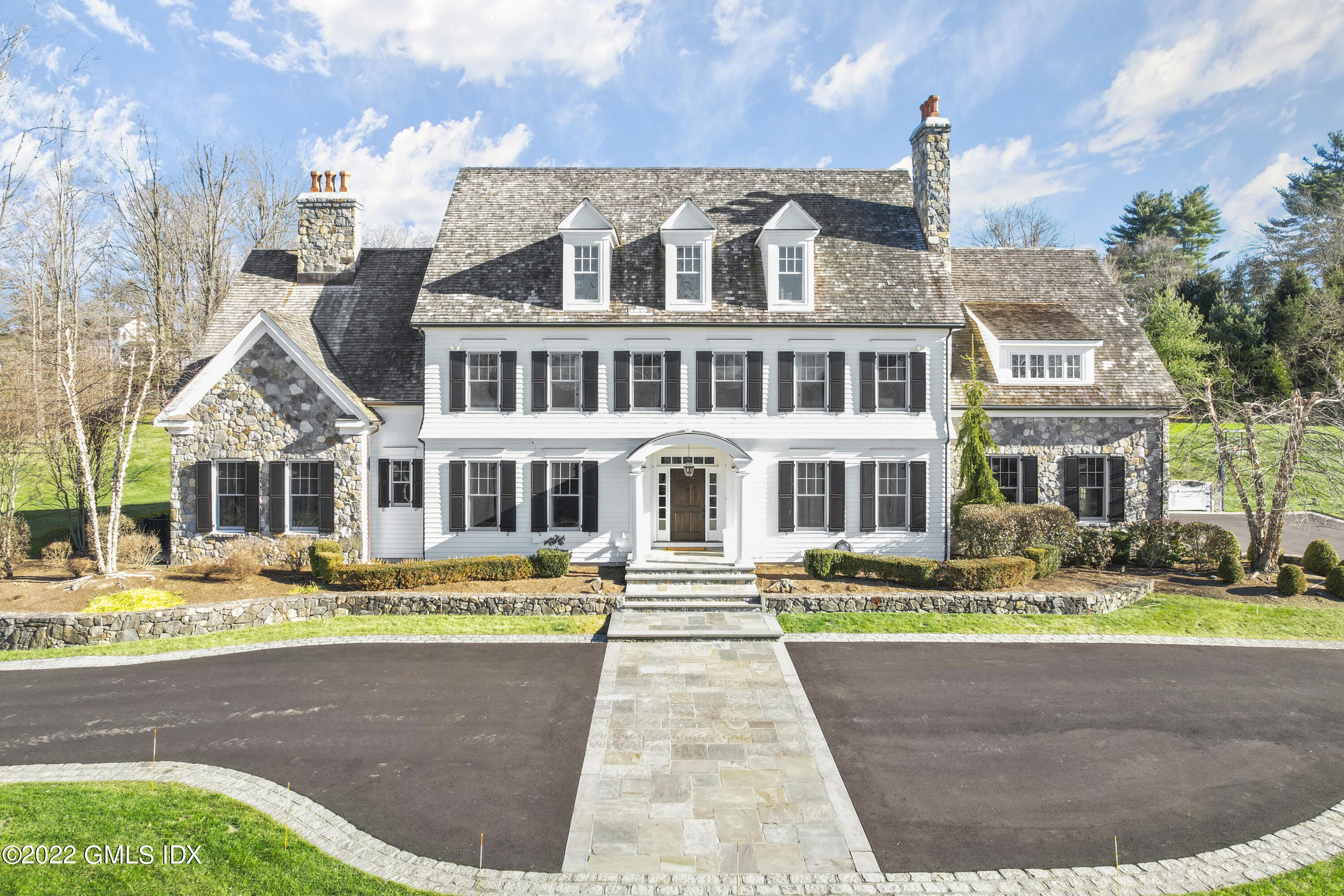 807 Lake Avenue Greenwich, CT 06830 - Photo 1 of 31 a front view of a building with garden and trees