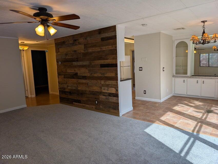 908 North Matterhorn Road Payson, AZ 85541 - Photo 4 of 59 a view of an empty room with a fireplace and a ceiling fan