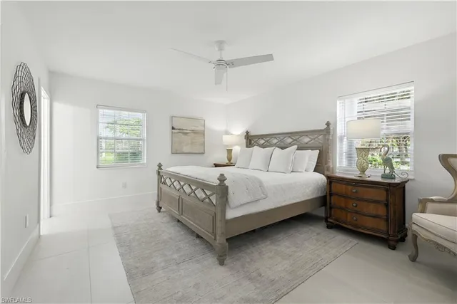 a bedroom with a bed chair and window