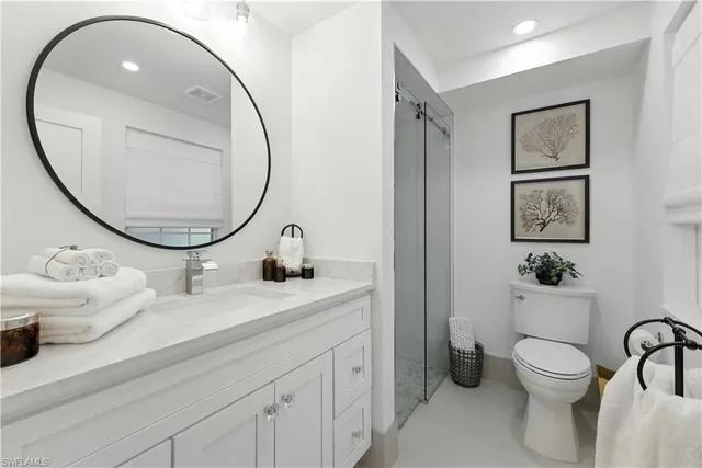 a bathroom with a toilet a sink and a mirror