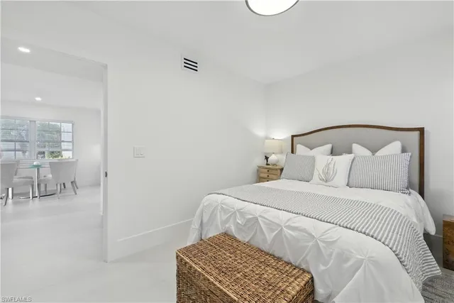 a bedroom with a bed and a mirror