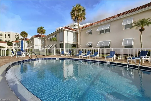 a view of a swimming pool with outdoor seating