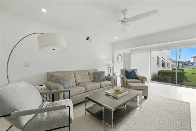 a living room with furniture a rug and a chandelier