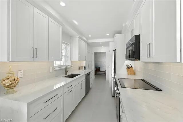 a kitchen with a sink cabinets and window