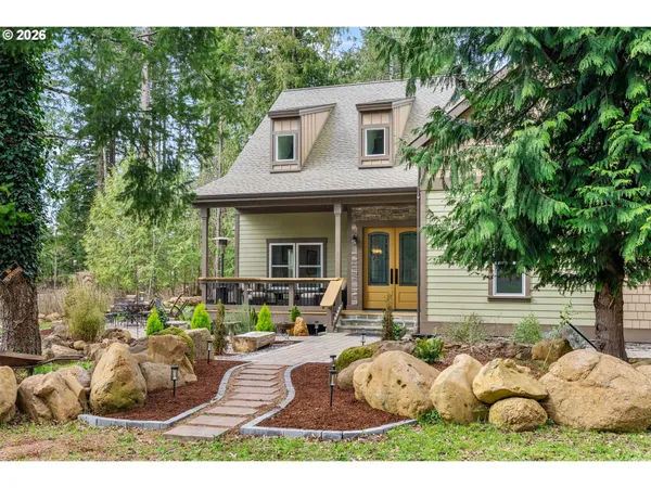 a view of a house with backyard and sitting area