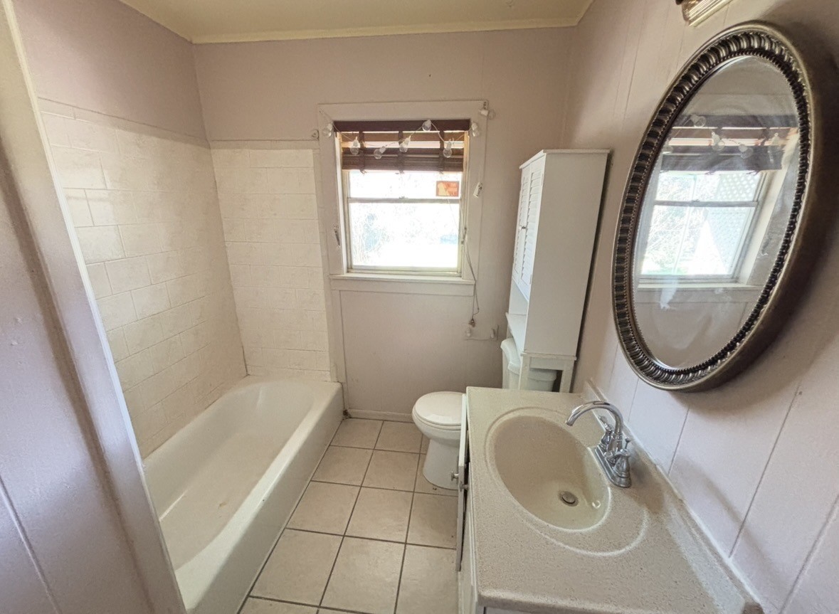 2208 Marshall Street Pasadena, TX 77506 - Photo 13 of 24 a bathroom with a sink a toilet and a mirror