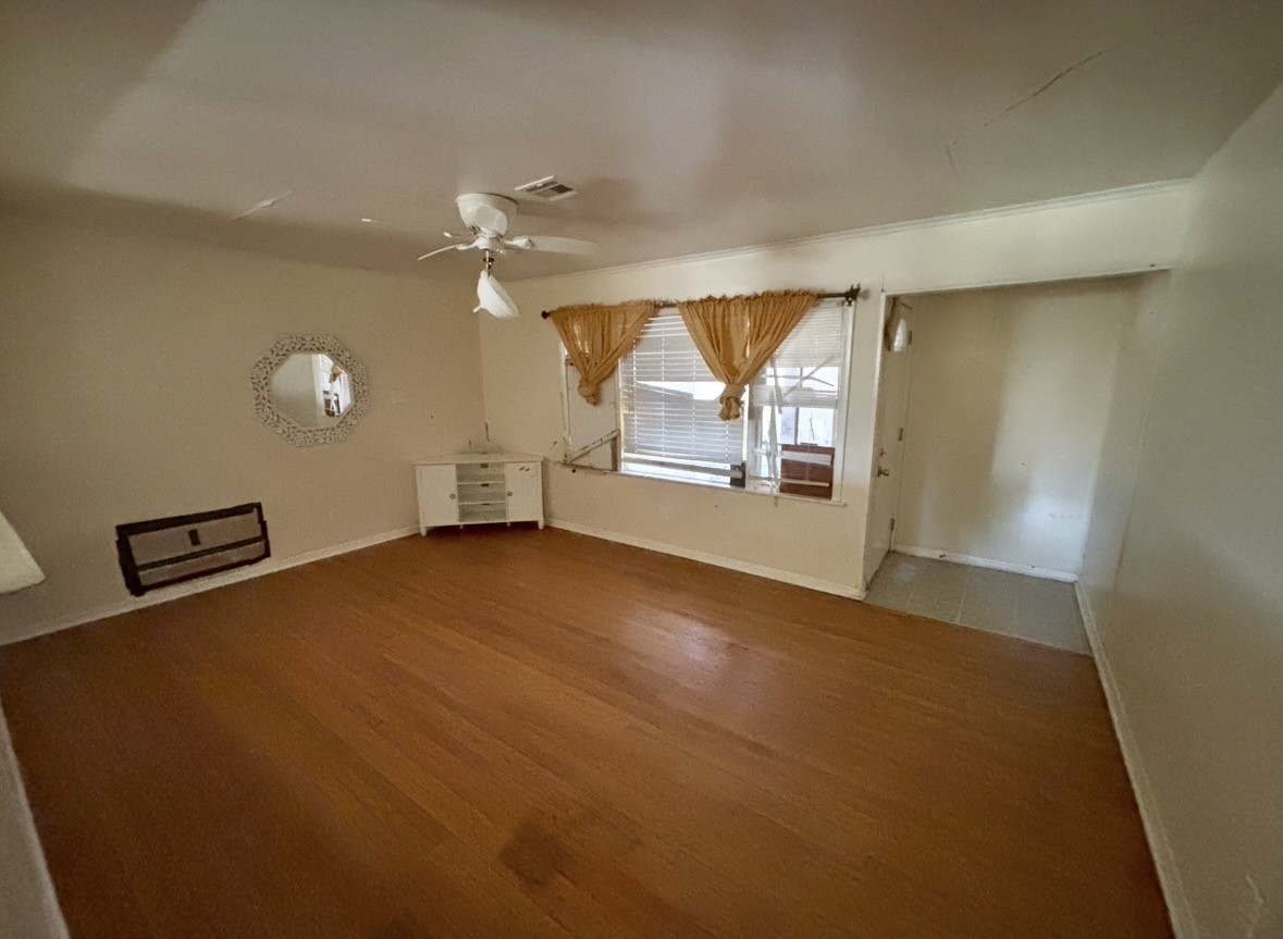 2208 Marshall Street Pasadena, TX 77506 - Photo 14 of 24 wooden floor in an empty room with a window