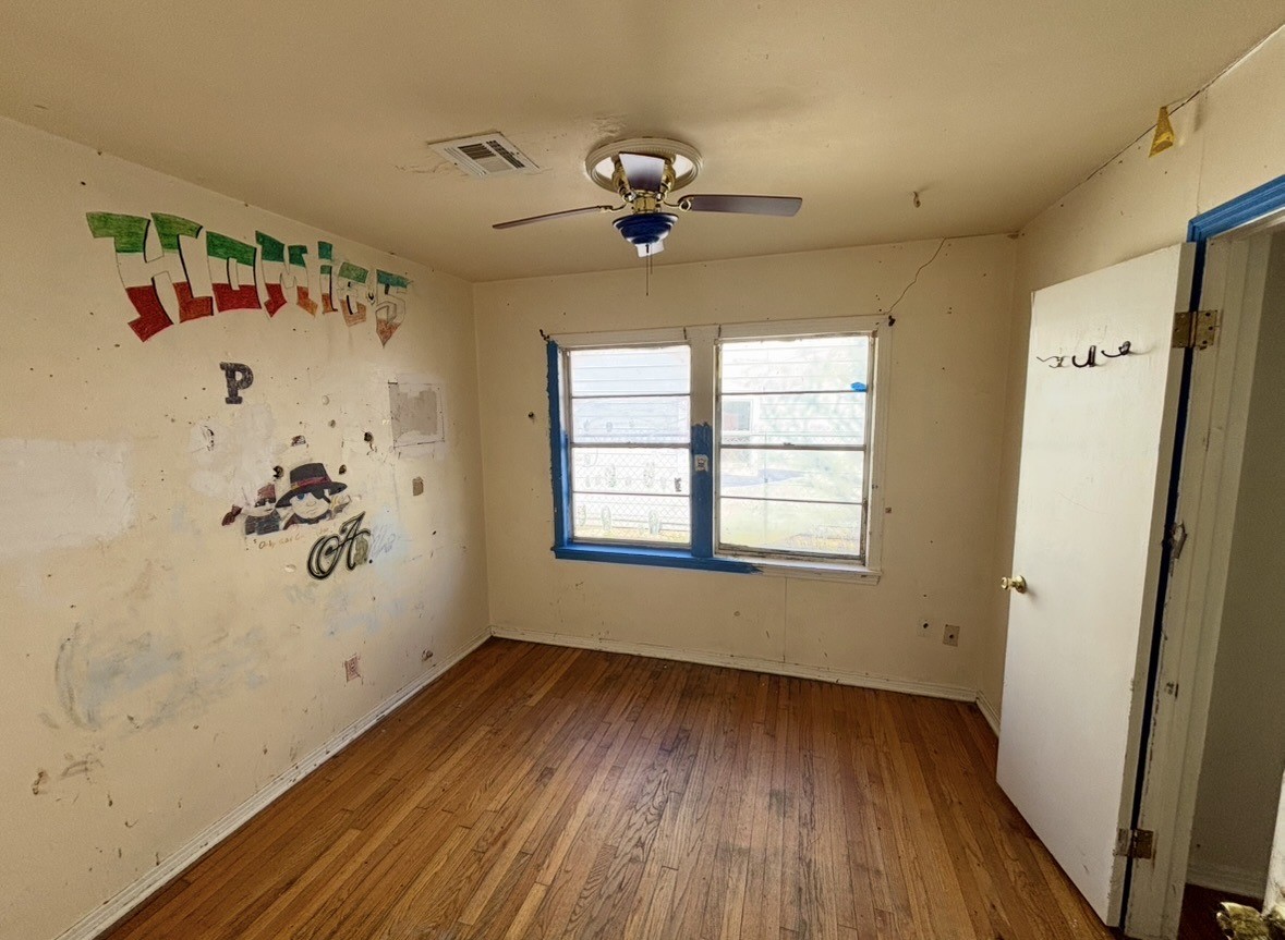 2208 Marshall Street Pasadena, TX 77506 - Photo 15 of 24 a view of a livingroom with wooden floor and a ceiling fan