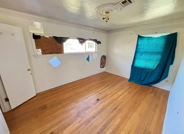 a bedroom with a bed and a mirror