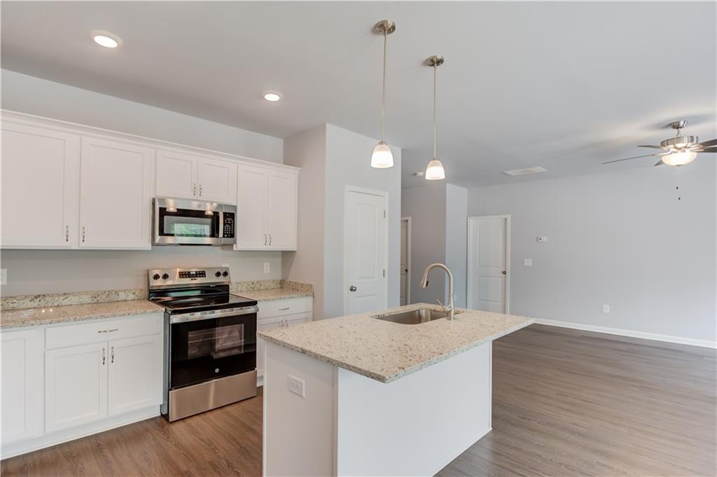 653 Dortch Road Eastanollee, GA 30538 - Photo 14 of 37 a kitchen with stainless steel appliances granite countertop a sink stove and refrigerator