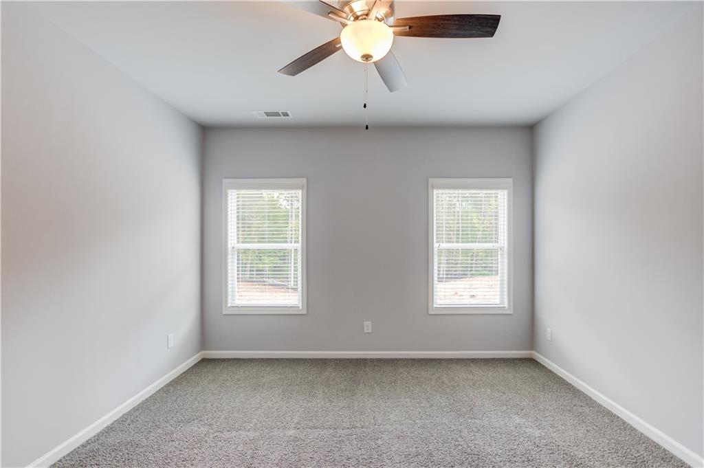 653 Dortch Road Eastanollee, GA 30538 - Photo 16 of 37 an empty room with chandelier fan and windows