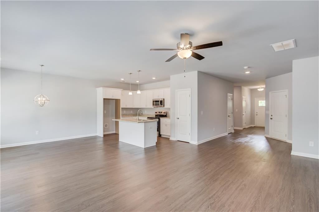 653 Dortch Road Eastanollee, GA 30538 - Photo 9 of 37 a view of an empty room and kitchen with wooden floor
