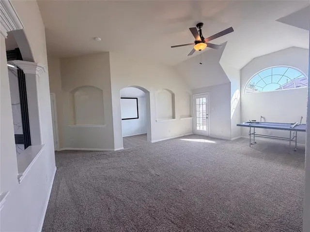 a view of a livingroom with a ceiling fan and window