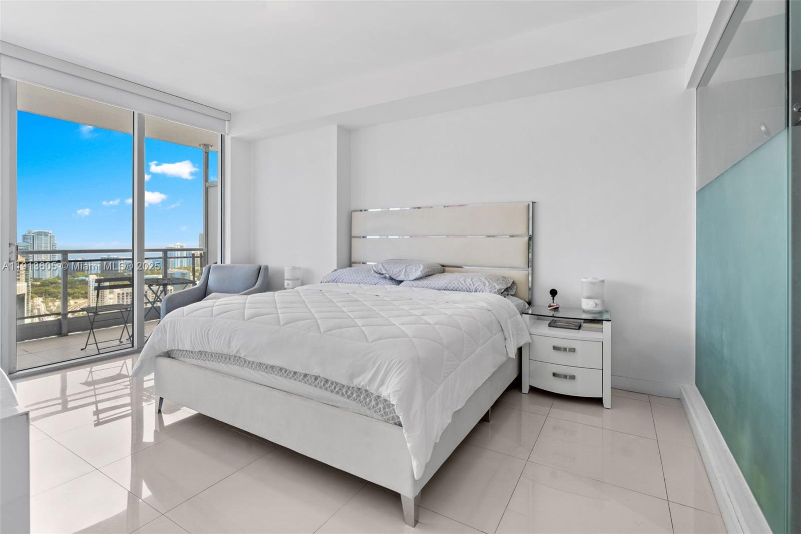 92 Southwest 3rd Street, Unit 4403 Miami, FL 33130 - Photo 12 of 28 a bed room with a bed and large window