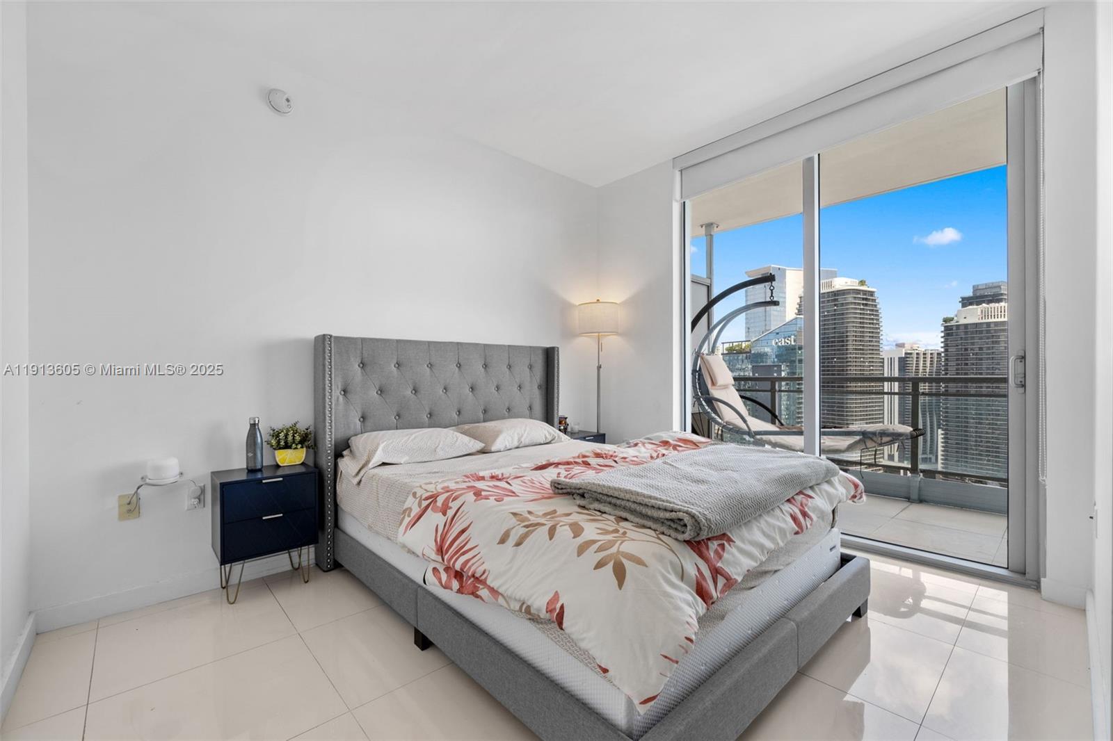 92 Southwest 3rd Street, Unit 4403 Miami, FL 33130 - Photo 17 of 28 a bedroom with a bed and a large window