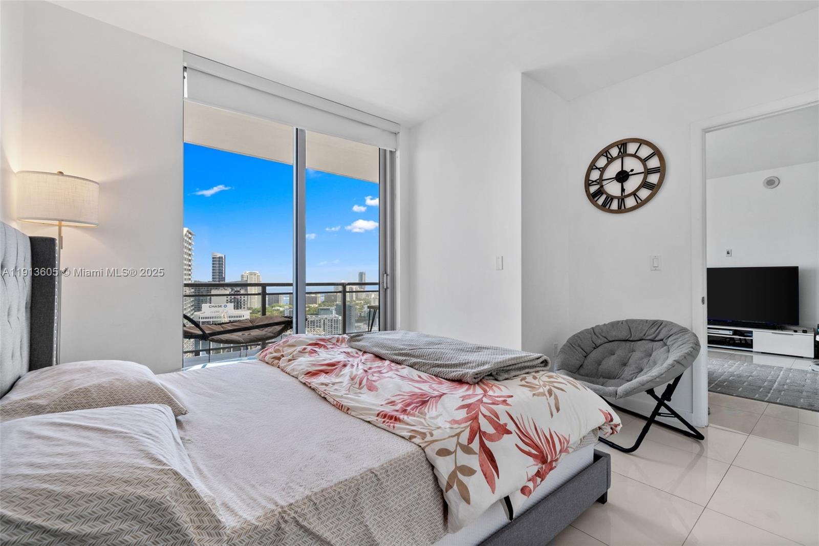 92 Southwest 3rd Street, Unit 4403 Miami, FL 33130 - Photo 18 of 28 a bedroom with a bed and a chair in it