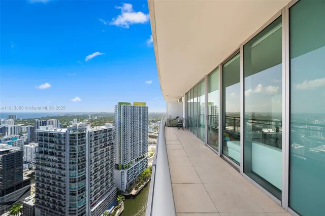 a view of swimming pool with outdoor seating and city view