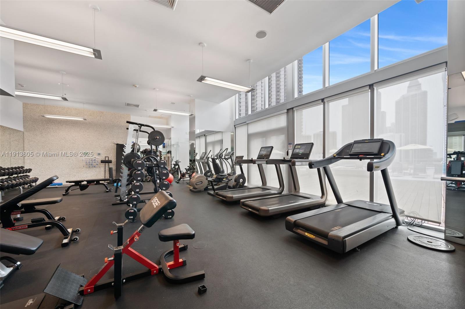 92 Southwest 3rd Street, Unit 4403 Miami, FL 33130 - Photo 26 of 28 a room with gym equipment and a large window