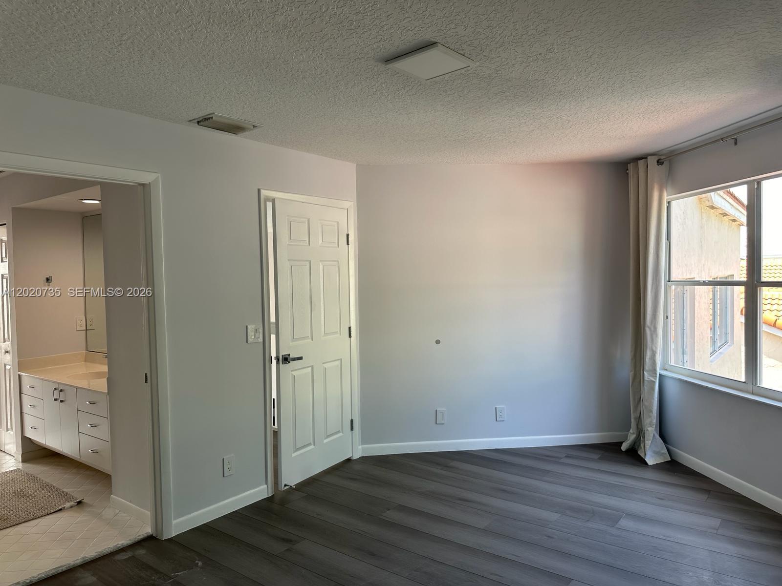 17244 Balboa Point Way Boca Raton, FL 33487 - Photo 20 of 66 an empty room with wooden floor and windows