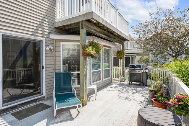 a view of a house with a patio and a yard