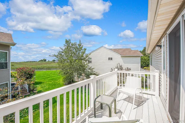 a view of a balcony with wooden floor and fence