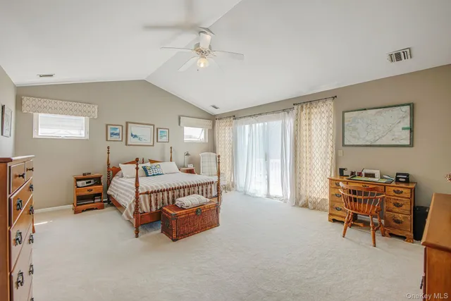 a spacious bedroom with a bed and a chandelier