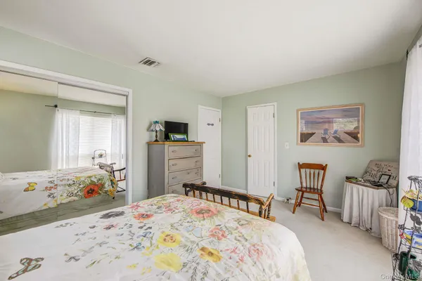 a bedroom with a bed and a dresser in it