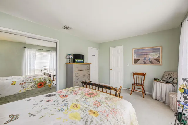 a bedroom with a bed and a dresser in it